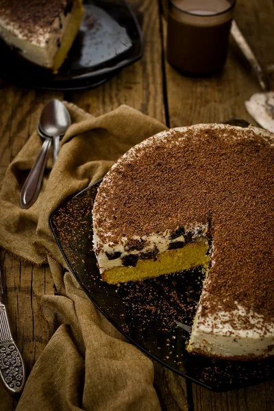 Cheesecake com ameixas secas e chocolate cortado em pedaços — Fotografia de Stock