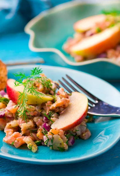Fish tartare  with apple on a blue plate. — Stock Photo, Image