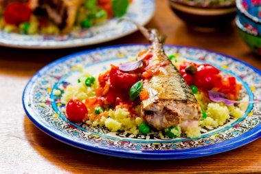 fried mackerel with tomato sauce and couscous  clipart