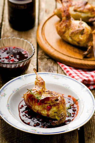 The baked quails with cowberry sauce — Stock Photo, Image