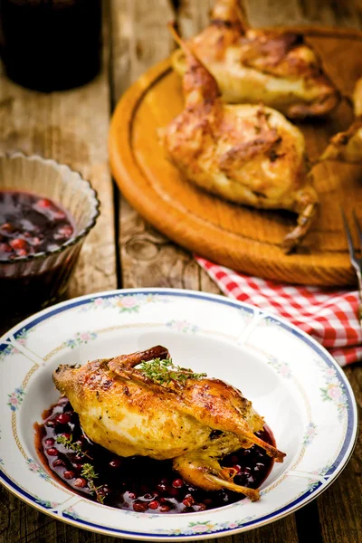 The baked quails with cowberry sauce — Stock Photo, Image