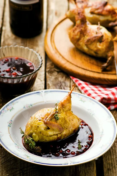 The baked quails with cowberry sauce — Stock Photo, Image