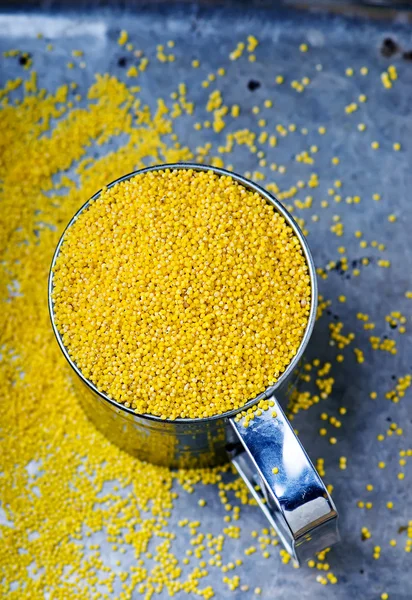 Millet in a metal mug on — Stock Photo, Image