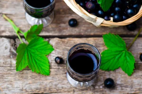 Liqueur from blackcurrant in a shot glass — Stock Photo, Image
