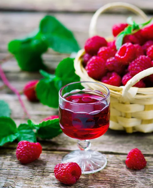 Liqueur from raspberry in a shot glass — Stock Photo, Image