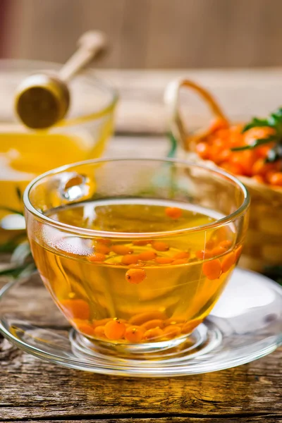 Hot drink from a sea-buckthorn in a glass cup — Stock Photo, Image