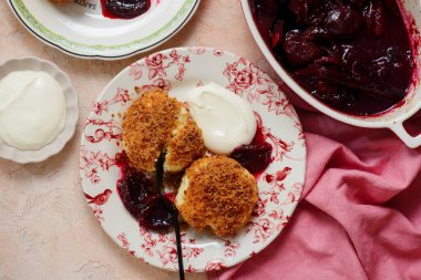 Geleneksel Avusturya süzme peynirli hamur köfteleri erik kompostosu ve ekşi krema ile. Top veiw.style sarılma. Seçici odak noktası