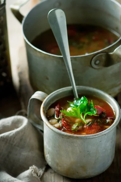 Sopa de feijão e salsichas e caneca de metal . — Fotografia de Stock