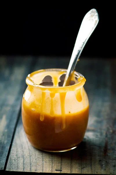 Butter caramel in a glass jar — Stock Photo, Image