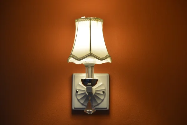 The lamp orange in the room.