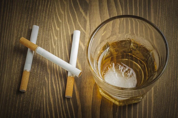 Сигареты и стакан алкоголя, образующие слово НЕТ — стоковое фото