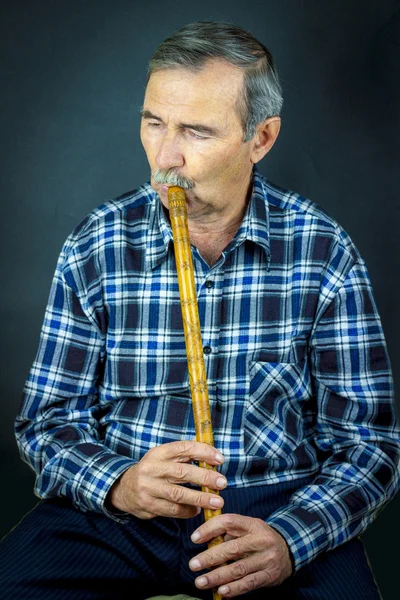 Man playing on pipe flute — Stock Photo, Image