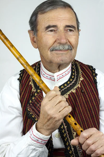 Pipe player in traditional clothing — Stock Photo, Image