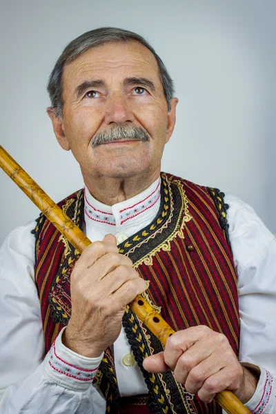 Pipe player in traditional clothing — Stock Photo, Image