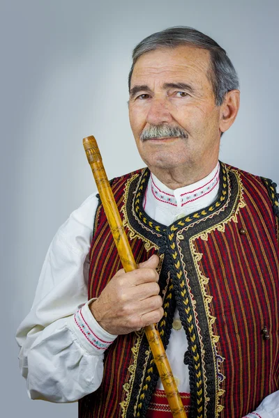 Pipe player in traditional clothing — Stock Photo, Image