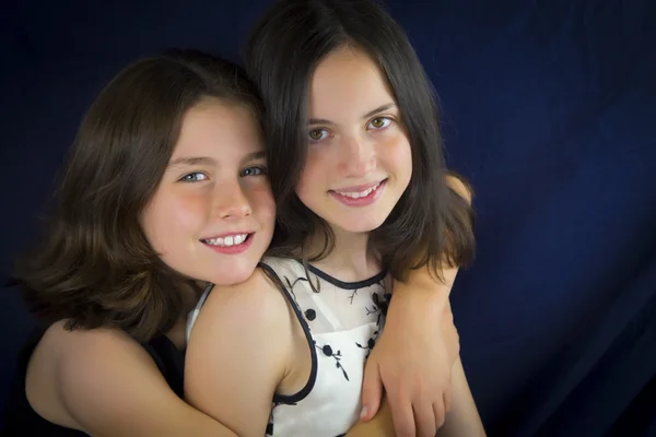 Bonitas hermanas sonriendo y abrazándose — Foto de Stock