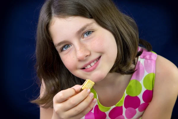 Beautiful teenage girl eating chocolate — Stock Photo, Image