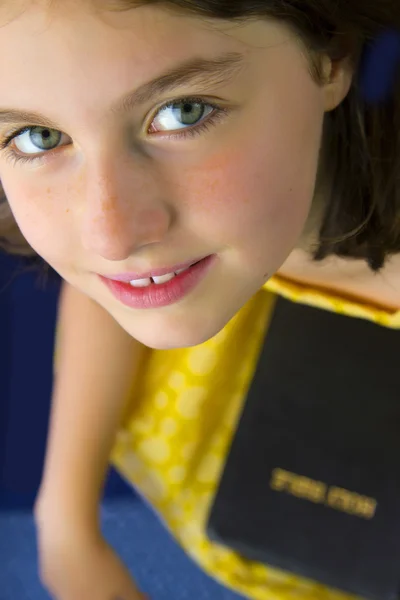 Portrait of beautiful little girl holding Holy Bible — Stock Photo, Image