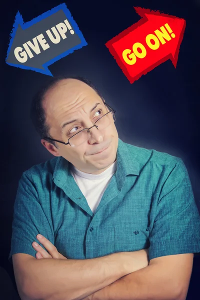 Adult man facing choice to GIVE UP or to GO ON — Stock Photo, Image