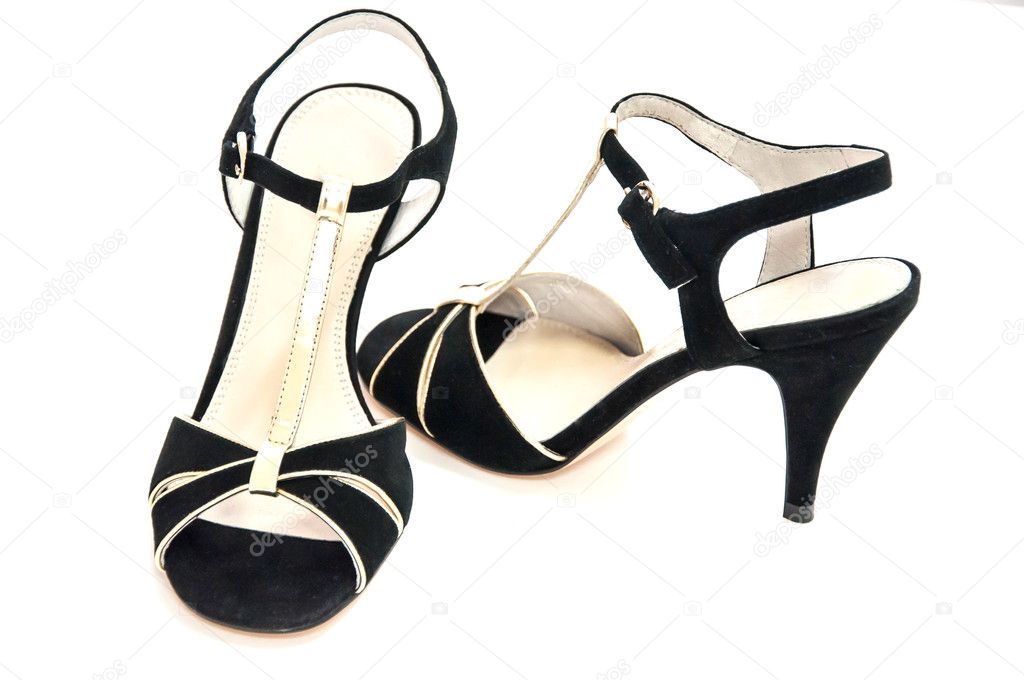 Pair of black womens high heeled shoes displayed for sale on white background.