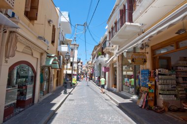 CRETE,RETHYMNO-JULY 23:Shopping Arkadiou street on July 23,2014 in Rethymnon city on the island of Crete, Greece. Arkadiou Street is one of the most important shopping centres in Rethymnon clipart