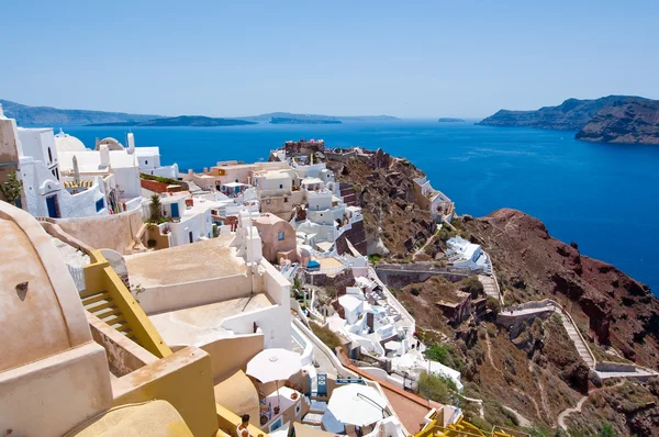 View of Oia town and the castle of Oia towards Thirassia, Thera (Santorini), Greece . — стоковое фото