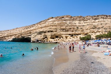 CRETE,GREECE-JULY 22: Matala beach with the caves on Libyan sea on July 22,2014 Crete, Greece.