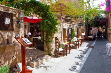 RETHYMNO,CRETE-JULY 23: Narrow stareet with cozy restaurants and bars on July 23,2014 in Rethymno city on Crete island, Greece. clipart