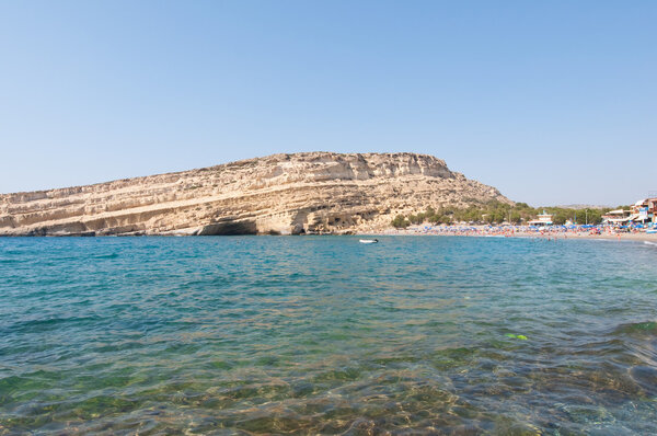Famous Matala hippy beach with caves on the Crete island, Greece.