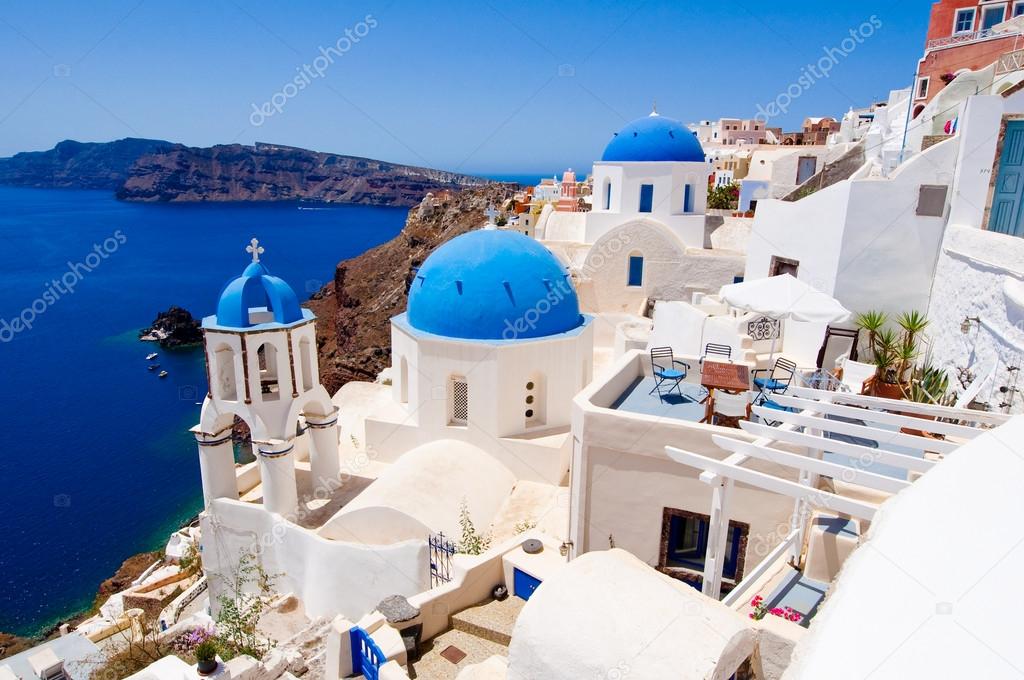 Oia church with blue domes and the bell on the island of Santorini, Greece