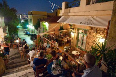 ATHENS-AUGUST 22: Street with various restaurants and bars on Plaka area, on August 22, 2014 in Athens. clipart