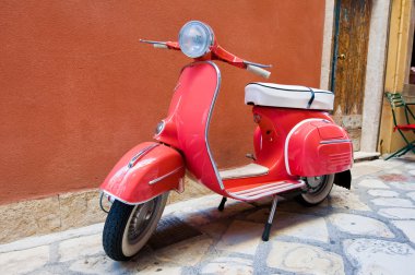 CORFU-AUGUST 22: Vespa scooter parked on Kerkyra street on August 22, 2014 on Corfu island. Greece. Vespa is an Italian brand of scooter manufactured by Piaggio.