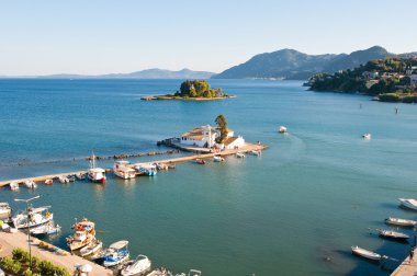Pontikonisi and Vlacheraina monastery on the Chalikiopoulou Lagoon as seen from the hilltop of Kanoni on the island of Corfu, Greece.