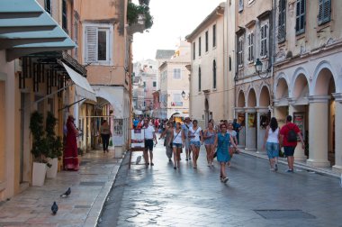 CORFU-AUGUST 22: Kerkyra narrow street in the hot weather with the row of souvenirs shops on August 22, 2014 on Corfu island, Greece.