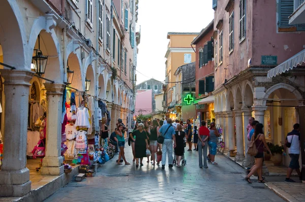 CORFU-AUGUST 22: Kerkyra old town in the evening with the row of souvenirs shops on August 22, 2014 on Corfu island, Greece. — Stock Photo, Image