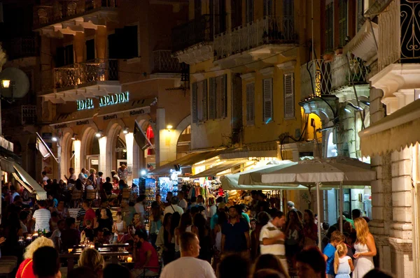 CORFU-25 DE AGOSTO: Multitud de personas en la calle Kerkyra por la noche el 25 de agosto de 2014 en la ciudad de Kerkyra en la isla de Corfú, Grecia . — Foto de Stock