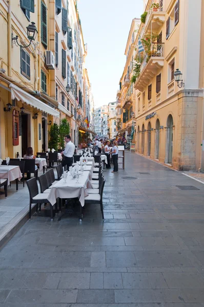 CORFU-AUGUST 22: Kerkyra city, local restaurants invite tourists to have a meal on August 22, 2014 on Corfu island, Greece. — Stock Photo, Image