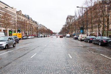 PARIS-JANUARY 10: The Avenue des Champs-Élysées in a bad weather on January 10,2013 in Paris.The Avenue des Champs-Élysées is a boulevard in the 8th arrondissement of Paris.