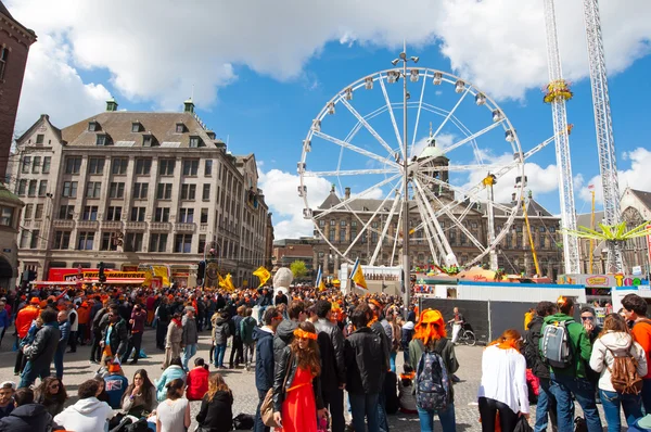 AMSTERDAM, PAÍSES BAJOS-ABRIL 27: Plaza Dam llena de gente en naranja durante el Día del Rey el 27 de abril de 2015 en Ámsterdam . — Foto de Stock
