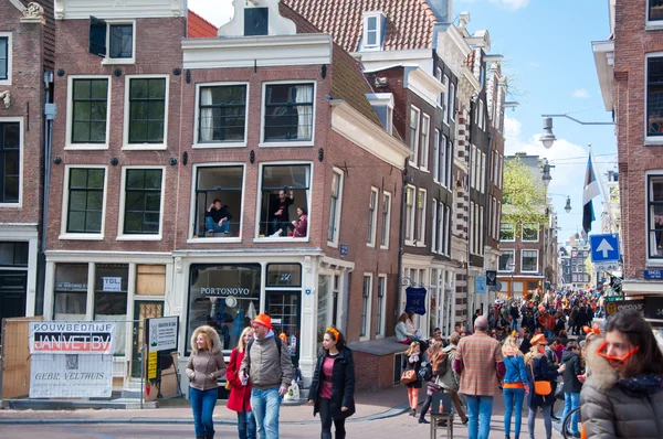 AMSTERDAM-ABRIL 27: Multitud de personas en naranja celebran el Día del Rey alrededor de la calle Amsterdam el 27 de abril de 2015 . — Foto de Stock