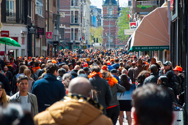 AMSTERDAM-APRIL 27:Thousands people on Amsterdam street, Rijksmuseum on the background during King's Day on April 27,2015, the Netherlands.