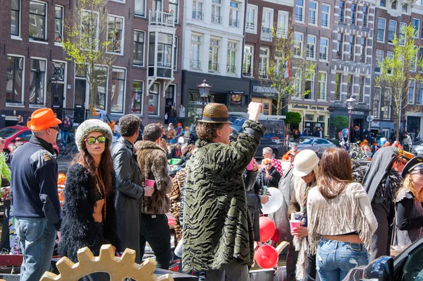 AMSTERDAM-APRIL 27: Unidentified people at the open-air party during King's Day on the Singel canal on April 27,2015, the Netherlands.