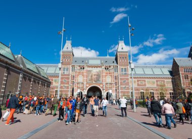 AMSTERDAM-APRIL 27: The Rijksmuseum on King's Day people walk to a public space (Museumplein)  on April 27, 2015.