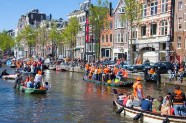 AMSTERDAM-APRIL 27: Party Boat with crowd of people along the canal on King's Day on April 27,2015, the Netherlands.