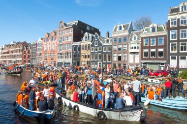 AMSTERDAM-APRIL 27: Crowd of people on the boats participate in celebrating King's Day on April 27,2015 the Netherlands.