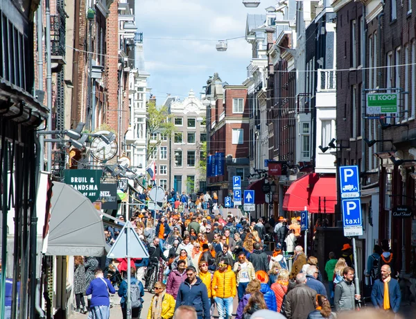 AMSTERDAM-APRIL 27: People on Amsterdam busy street celebrate King's Day on April 27,2015, the Netherlands.