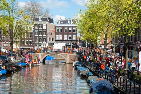 AMSTERDAM-APRIL 27: Crowd of people go along Amsterdam street to celebrate King's Day on April 27,2015.
