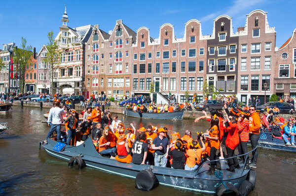 AMSTERDAM-APRIL 27: Locals on the boats participate in celebrating King's Day through Singel canal on April 27,2015.