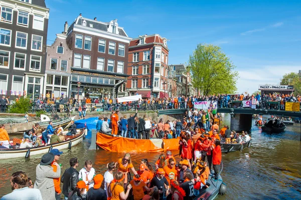 AMSTERDAM-APRIL 27: Locals and tourists on the boats participate in celebrating King's Day on April 27,2015 the Netherlands.