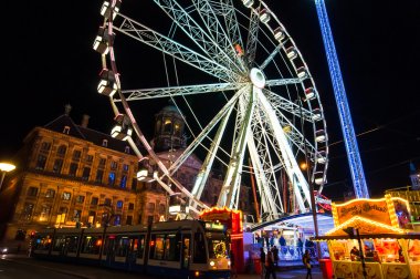 AMSTERDAM,NETHERLANDS-APRIL 27:  King's Day on Dam Square at night with amusement park on April 27,2015 in Amsterdam.
